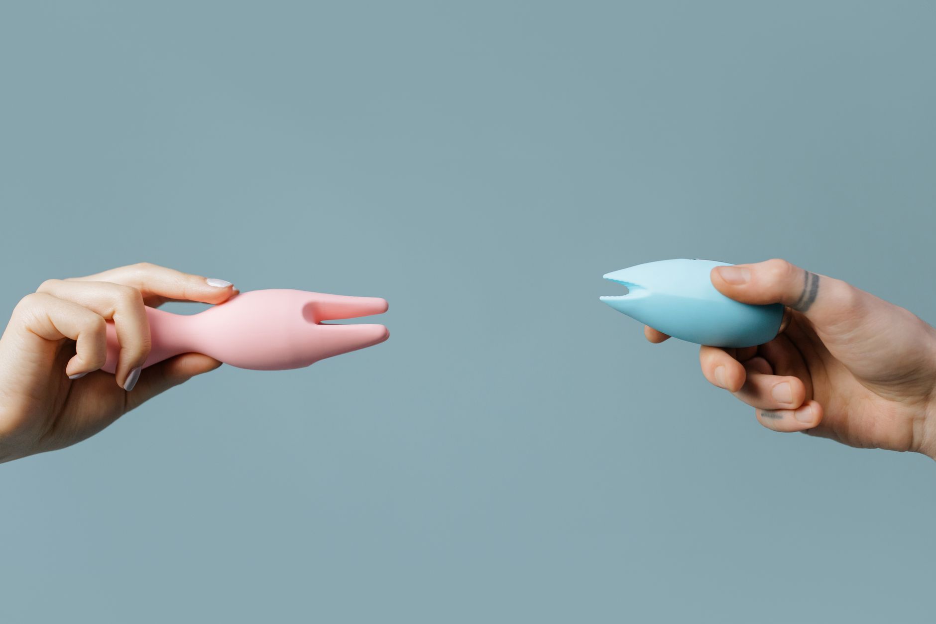 A couple standing together holding a vibrator, representing modern shared intimacy and communication