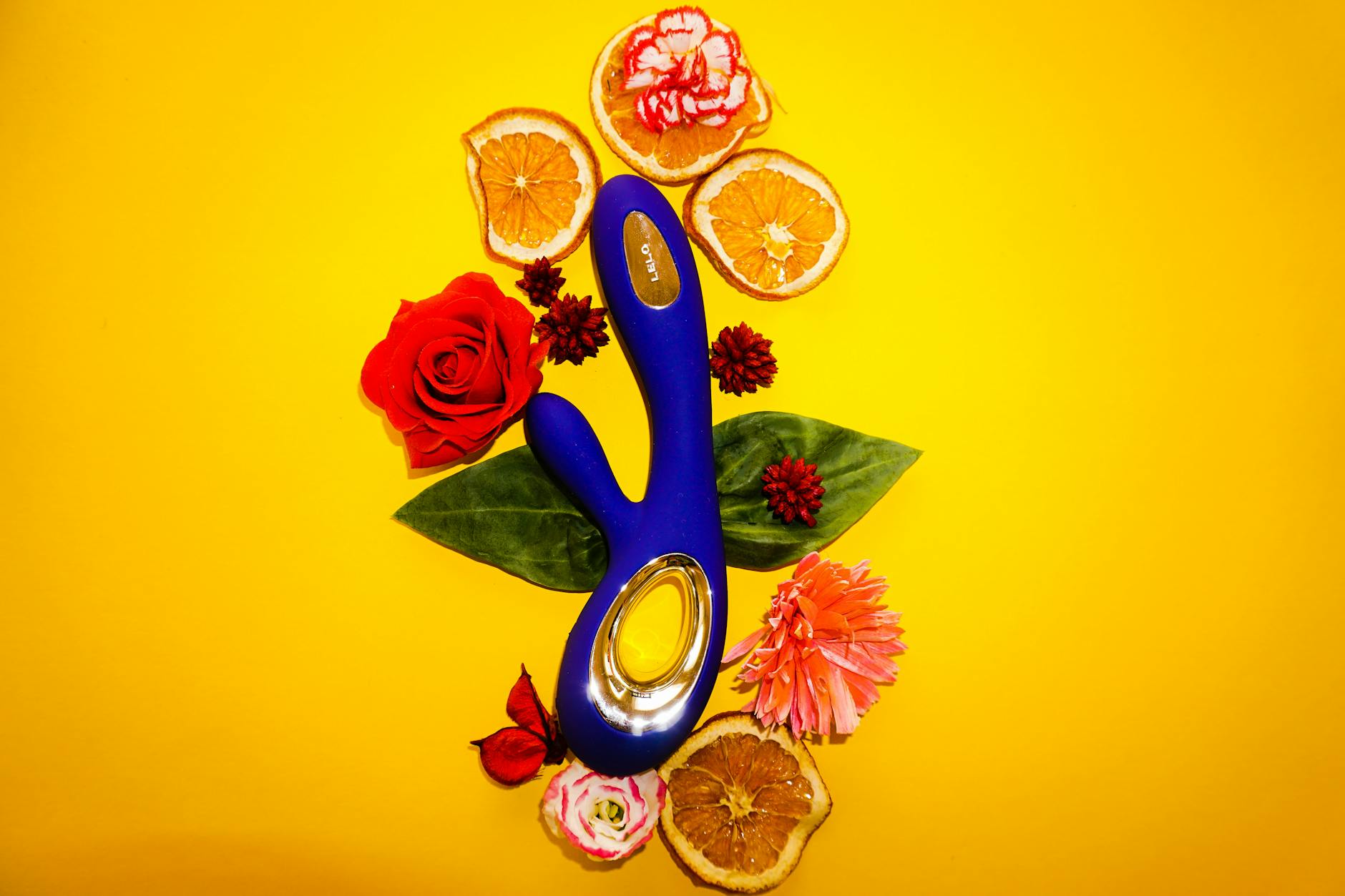 A blue silicone sex toy held in hand against a solid purple background, promoting self-love and sexuality.